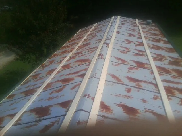 Rusted metal roof panels with new wood purlins before replacement — Storm Damage Roof Repair in Kaufman by Roofing Brothers